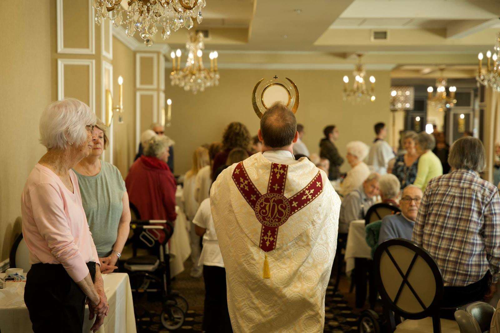 Elementary students accompany Christ in Eucharistic procession through senior home in Canada